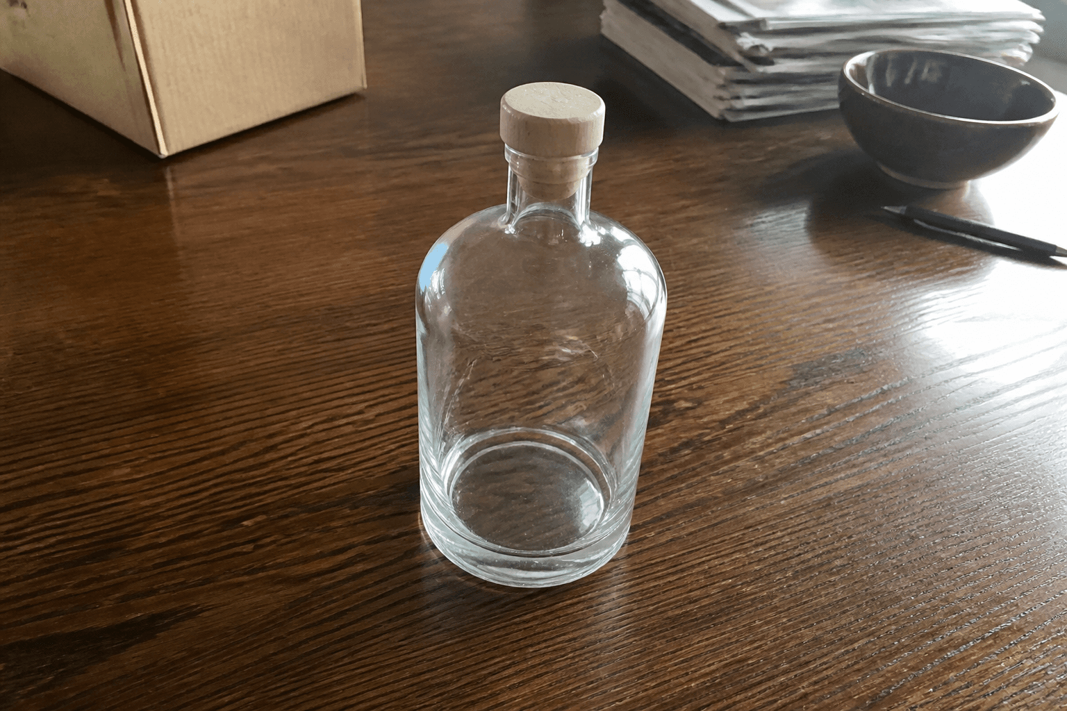 Phone photo of a glass bottle on a wooden table